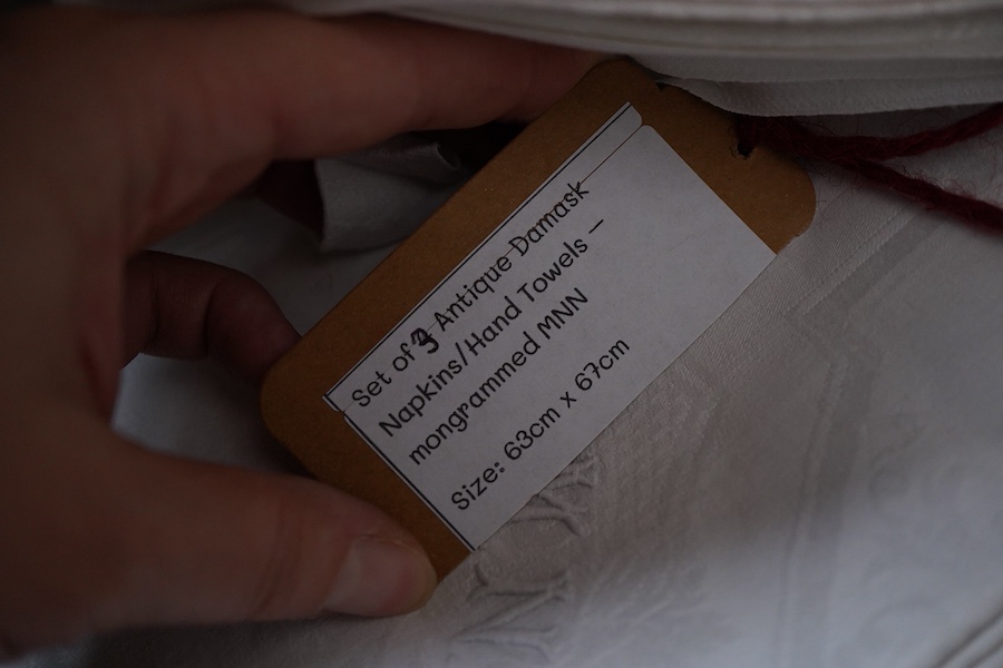 A collection of four sets of ten monogrammed French linen napkins and a similar set of twelve napkins, various odd sets of English Damask napkins, a large damask table cloth and a set of hand towels.